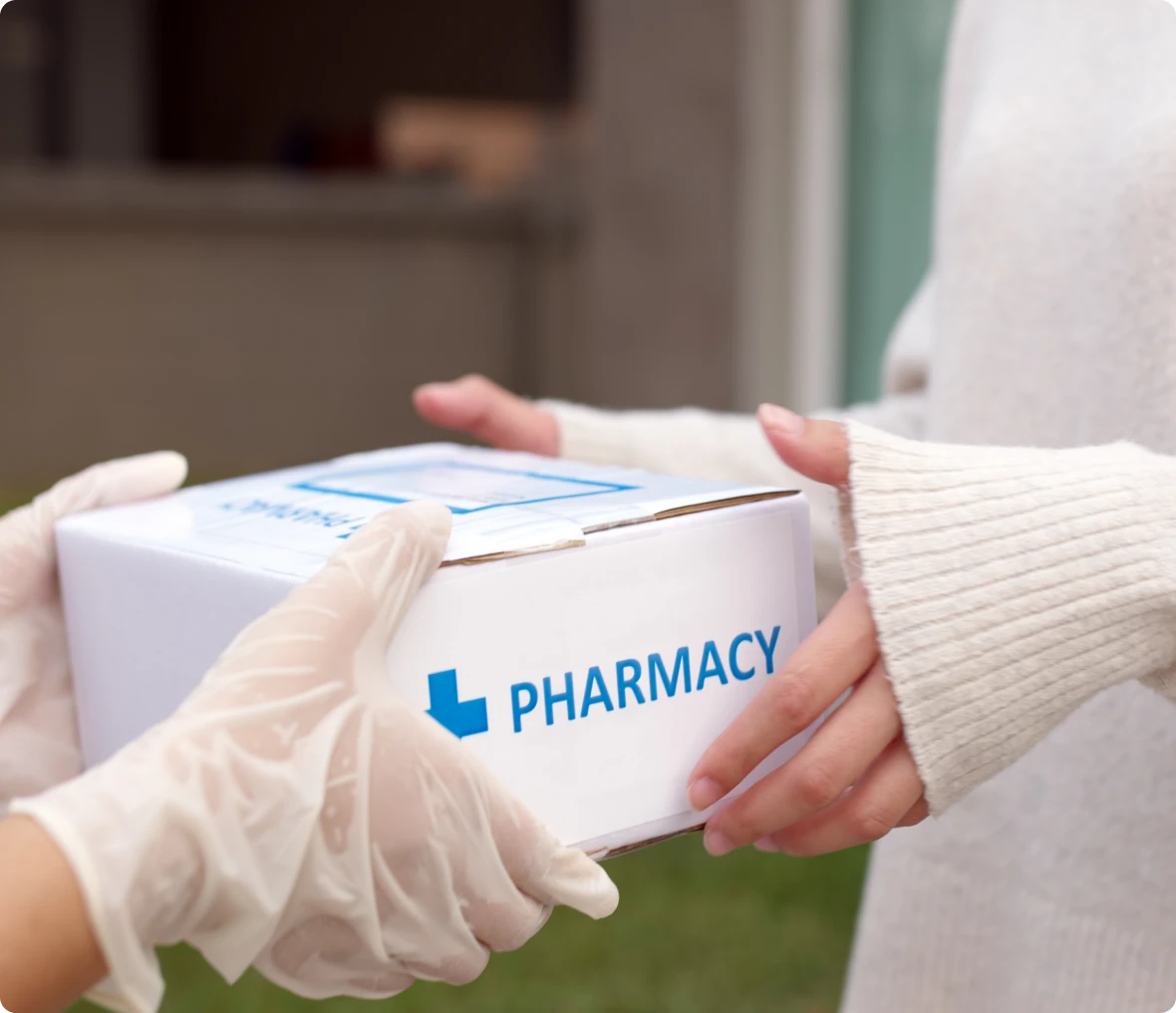Gloved hand delivering pharmacy package